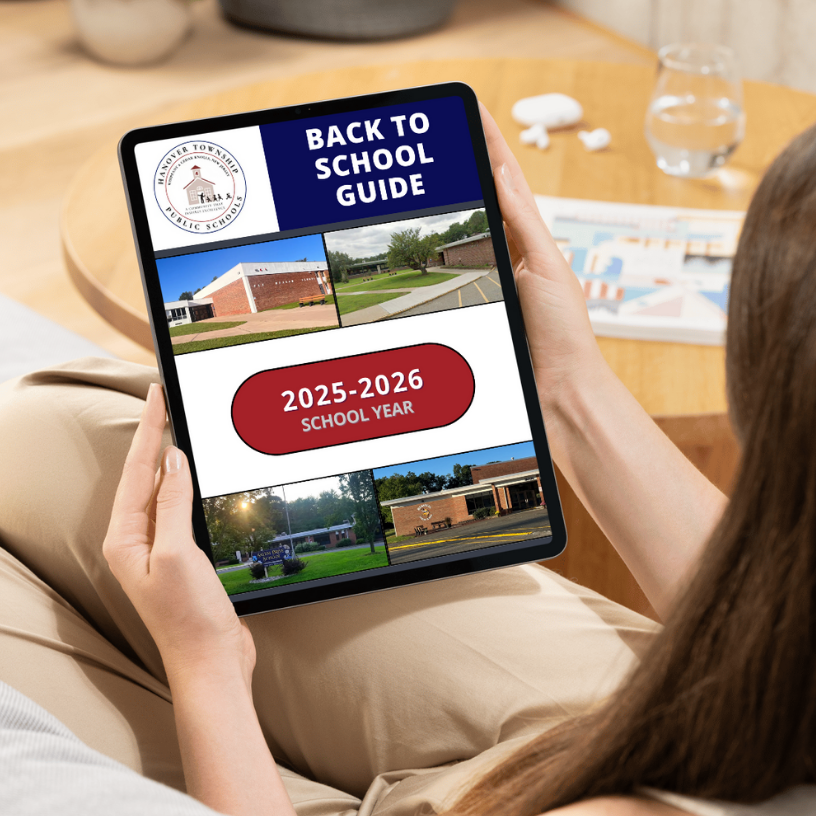 a group of people looking at a laptop